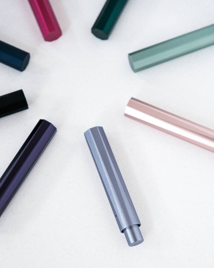 Colorful pens arranged on a white surface